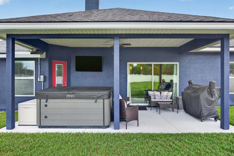Covered patio with outdoor TV and furniture at 538 Porta Rosa Circle, St. Augustine, FL 32092