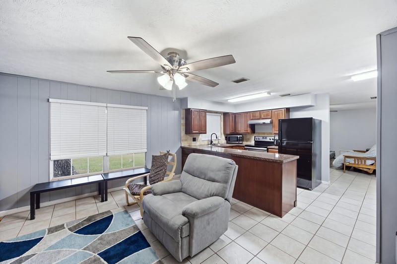 Living room open to kitchen with recliner at 417 Capricorn Ln, Orange Park, FL 32073