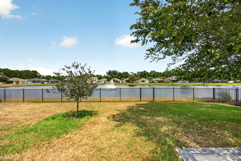 Backyard with vinyl fence and lake view at 85 Amia Dr, St. Augustine, FL 32086