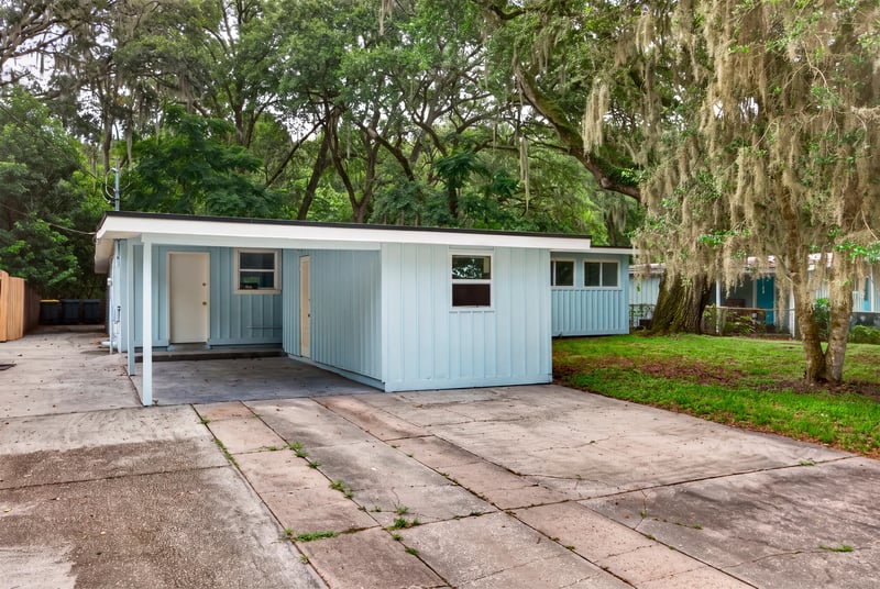 Front exterior with carport and oak canopy at 3113 Kline Rd, Jacksonville, FL 32246