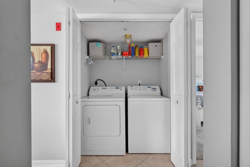 Laundry closet with stacked washer and dryer at 206 16th St, St. Augustine, FL 32080