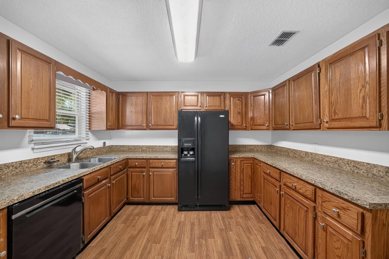 Kitchen counter with granite-style surface and window at 892 Branscomb Rd, Green Cove Springs, FL
