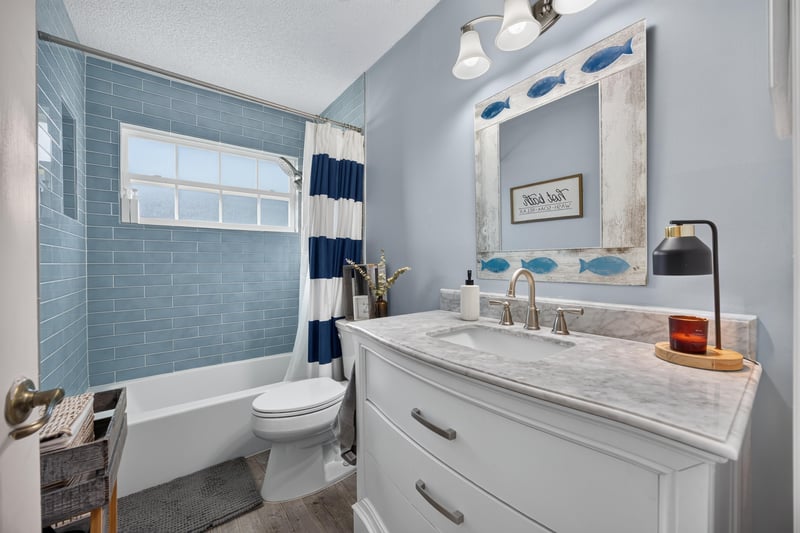 Bathroom with tub-shower combo and striped curtain at 4556 Shaky Leaf Ln N, Jacksonville, FL 32224