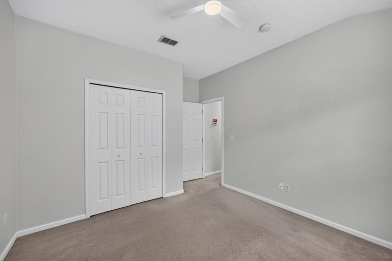 Bedroom with door and window at 2480 Ridge Will Dr, Jacksonville, FL 32246