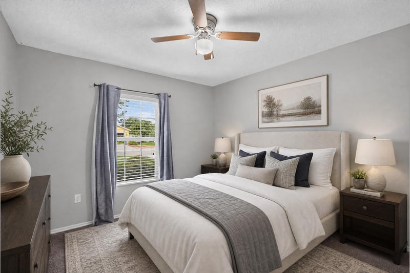 Staged bedroom with bed and wall art at 7545 Lirope St, Jacksonville, FL 32244