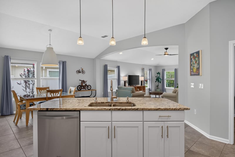 Open kitchen and living area with pendant lights at 85 Amia Dr, St. Augustine, FL 32086