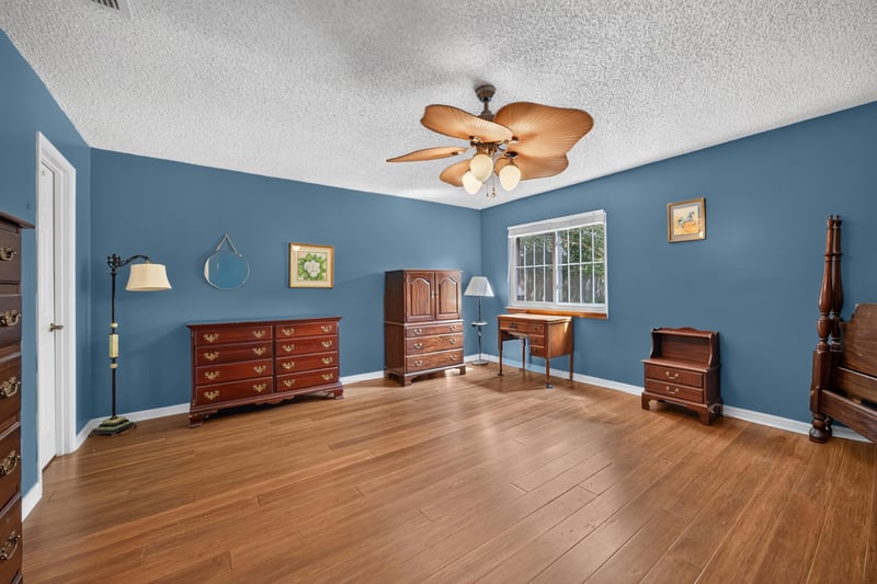 Bedroom with blue walls and wood dresser at 4837 Pareja Ct, Jacksonville, FL 32225