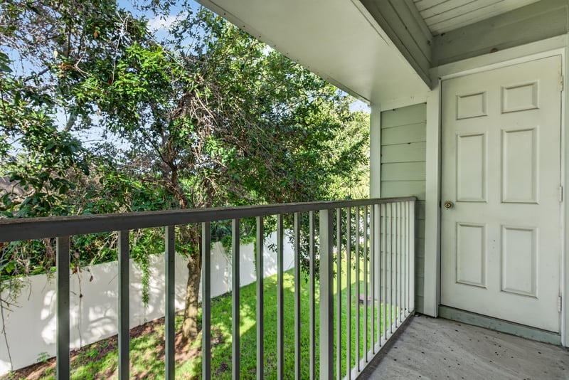 Covered balcony with railing at 7047 Deer Lodge Cir, Jacksonville