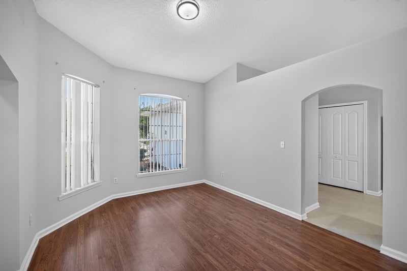 Empty room with large window and arched doorway at 9691 Nelson Forks Dr, Jacksonville, FL 32222
