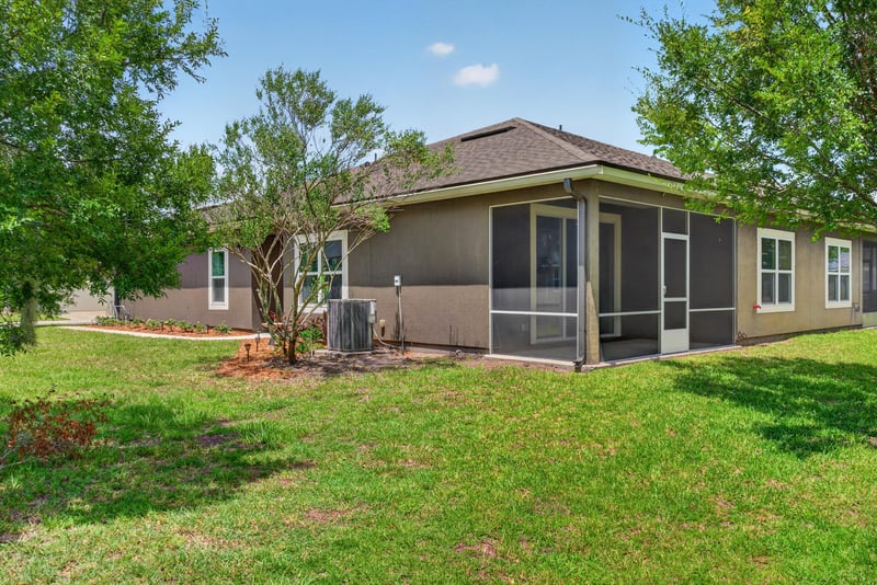 Backyard lawn with trees at 2378 Caney Oaks Dr, Jacksonville, FL