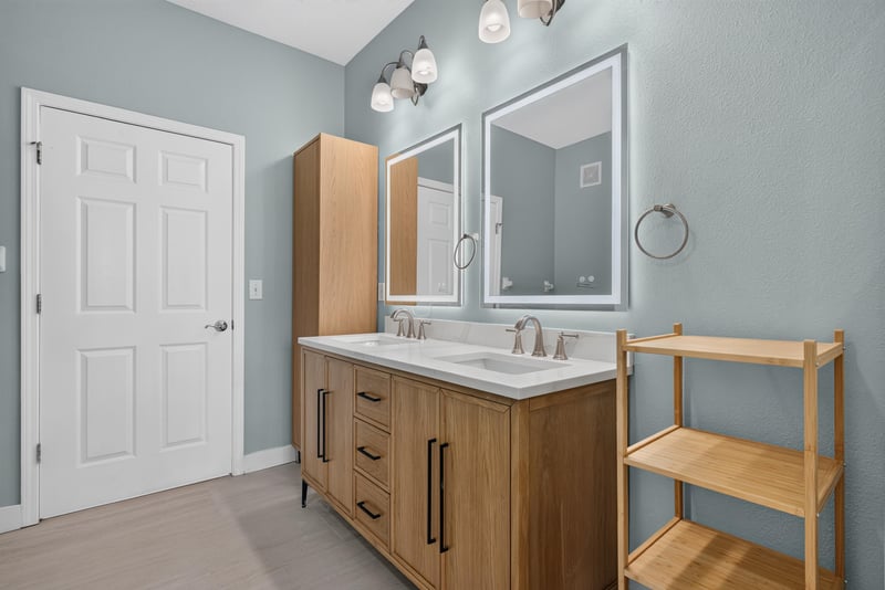 Primary bathroom with double vanity and wood shelving at 11251 Campfield Dr unit 1202, Jacksonville, FL 32256