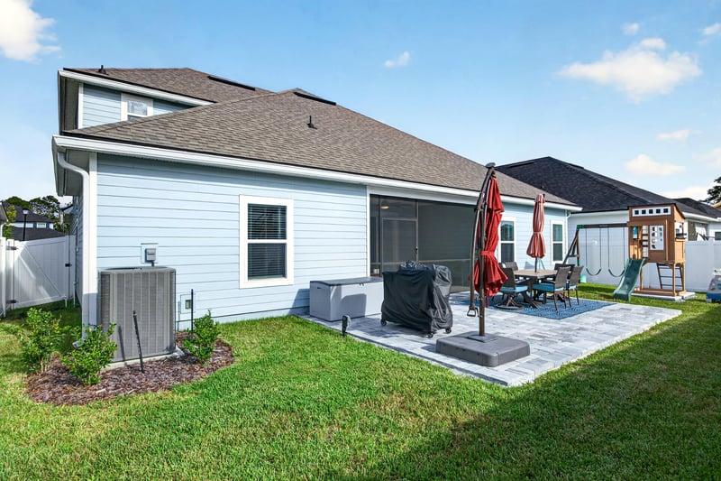 Backyard view with patio and fenced yard at 2354 Jennings Farm Dr, Middleburg, FL 32068