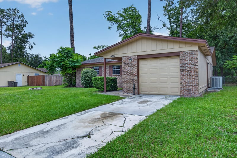 Front exterior from driveway with brick and vinyl siding accents at 1083 Stokes St, Jacksonville, FL