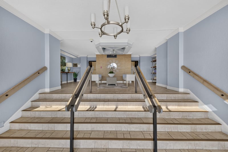Entry hallway with steps down and chandelier at 1301 1st St S
