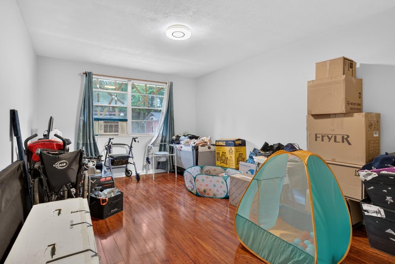 Room with hardwood floor and storage boxes at 5745 110th St, Jacksonville, FL 32244