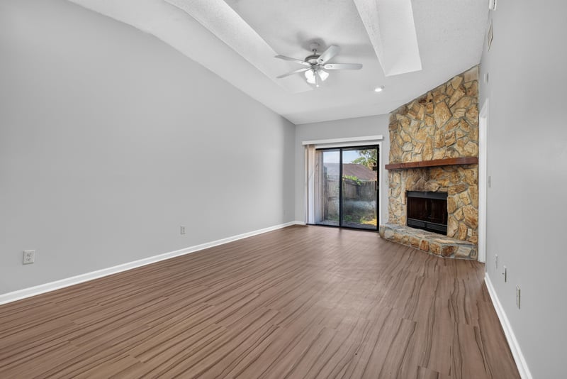 Living room with stone fireplace at 8010 International Village Dr, Jacksonville, FL 32277