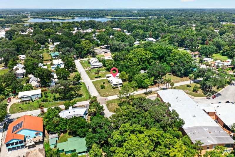 Drone view of neighborhood streets and tree canopy in Crescent City, FL