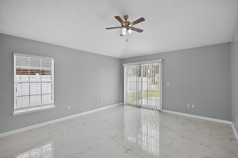 Living room with sliding glass door and tile flooring at 490 Hillside Dr, Orange Park, FL 32073