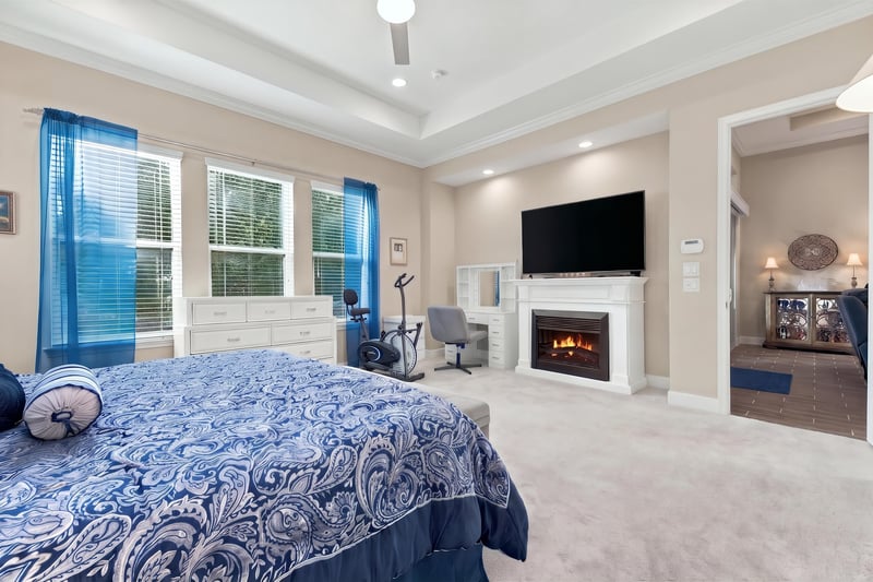 Primary bedroom with sitting area and fireplace, photographed by Megapixeler on Lucena Ln, Jacksonville, FL