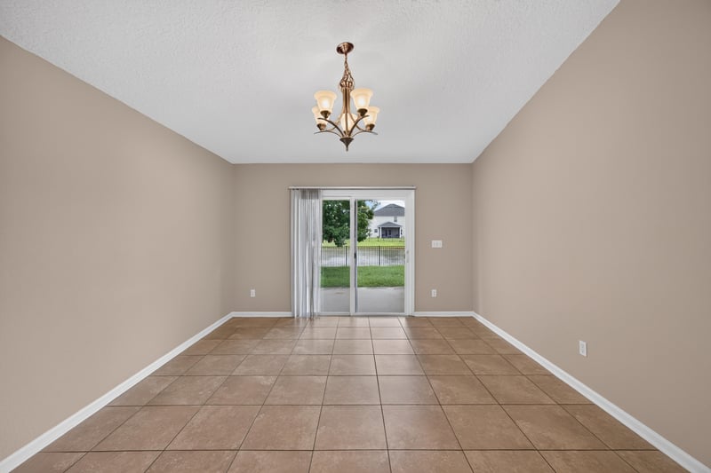 Living room with chandelier and tile floor at 469 Glendale Ln, Orange Park, FL