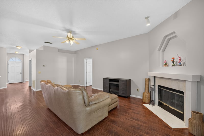 Living room with fireplace and wood floor at 11828 Heather Grove Ln, Jacksonville, FL