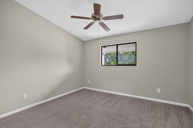 Empty bedroom with ceiling fan and window at 3801 Crown Point Rd, Jacksonville, FL 32257