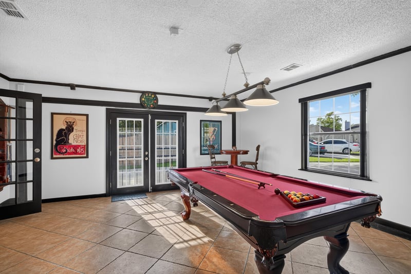 Game room with pool table and French doors at 6931 Cane Grass Ln E, Jacksonville, FL 32244
