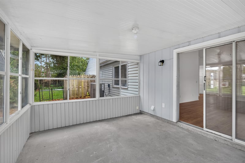 Sunroom interior with sliding glass door to patio at 8047 Mactavish Way E, Jacksonville, FL 32244