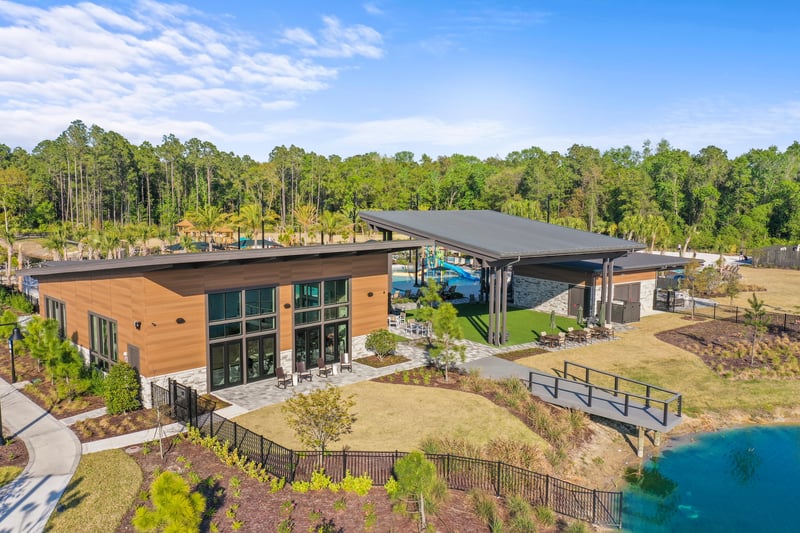 Aerial view of amenity building beside pond in St. Johns, FL