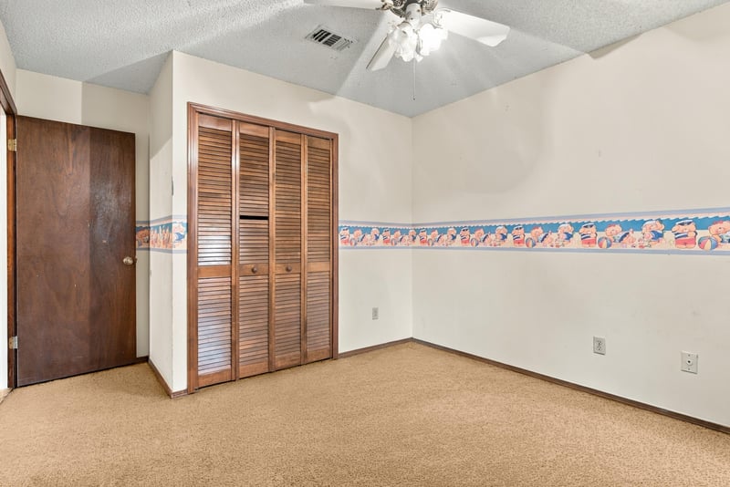 Bedroom with louvered closet doors at 2915 Trenton Ct, Orange Park, FL