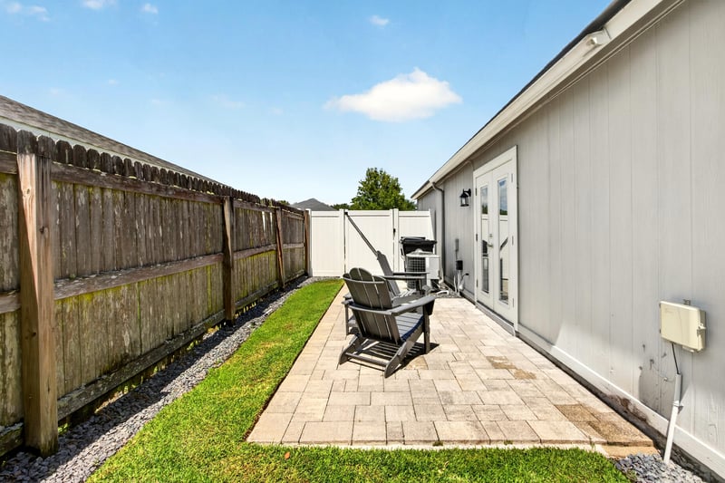 Covered porch with seating overlooking the yard at 3067 Wavering Ln, Middleburg, FL 32068