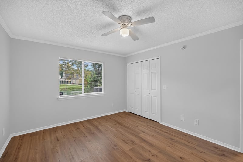 Bedroom corner with window and ceiling fan at 8047 Mactavish Way E, Jacksonville, FL 32244