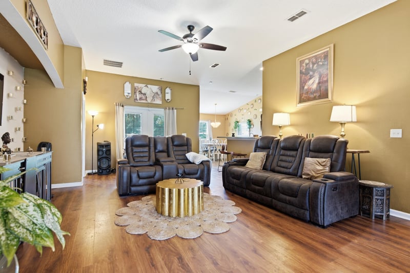 Living room with leather sofas and lamp lighting at 7392 Timber Falls Ct