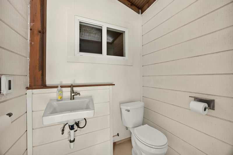 Pool bathroom with sink and toilet at 1589 Backwater Drive, Middleburg, FL 32068