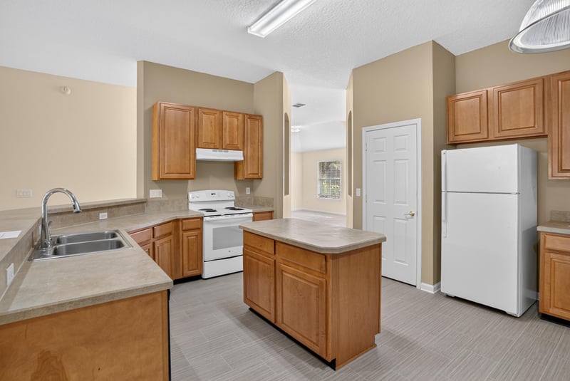 Kitchen with white appliances and refrigerator at 299 John's Creek Pkwy, St. Augustine, FL 32092