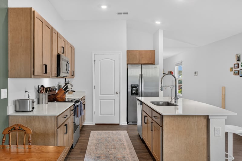 Kitchen island with white quartz counter at 4276 Quaking St, Jacksonville, FL 32218