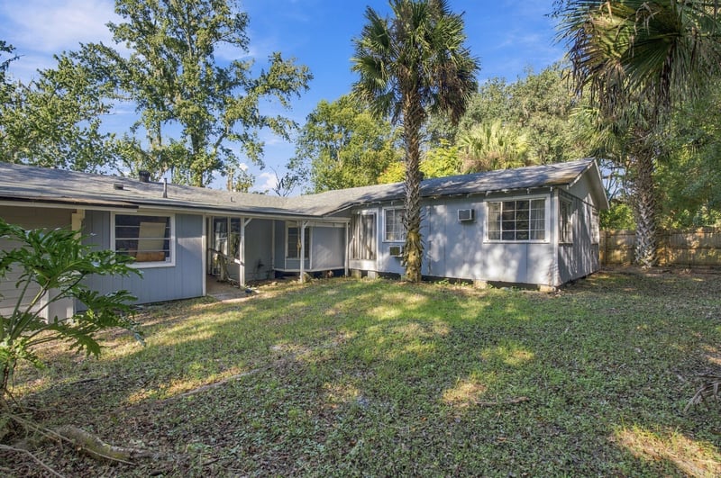 Wide exterior view of the house and surrounding trees at 1807 Idlewild Ave, Green Cove Springs, FL