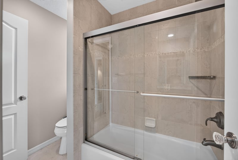 Bathroom with glass shower enclosure at 117 Island Cottage Way, St. Augustine, FL 32080