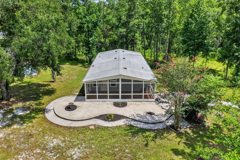 Aerial overhead view of home with screened porch and round patio at 4890 McAllister Rd, Middleburg, FL 32068