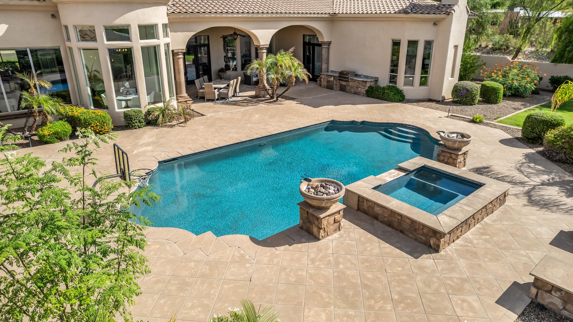 Aerial of a free-form pool and spa with fire bowls