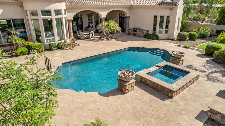 Aerial of a free-form pool and spa with fire bowls