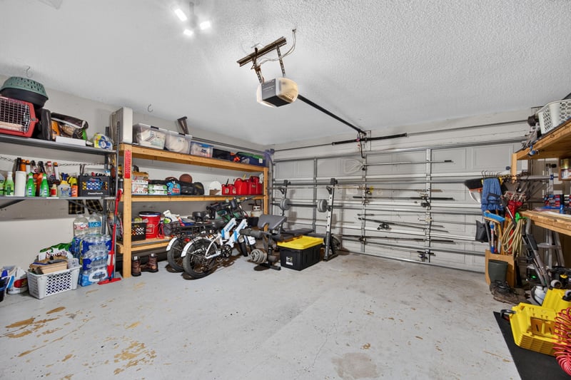 Garage with storage shelving at 1589 Backwater Drive, Middleburg, FL 32068