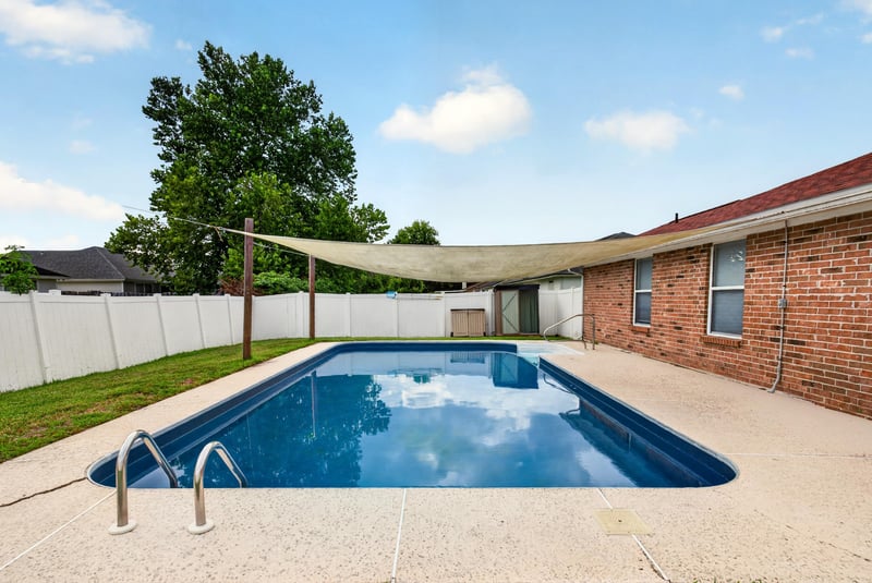 Backyard pool with shade sail at 2164 Orangewood St, Middleburg, FL 32068