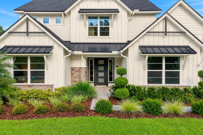 Front exterior with stone accents and covered entry at 907 Seagrove Dr, Ponte Vedra Beach, FL 32081