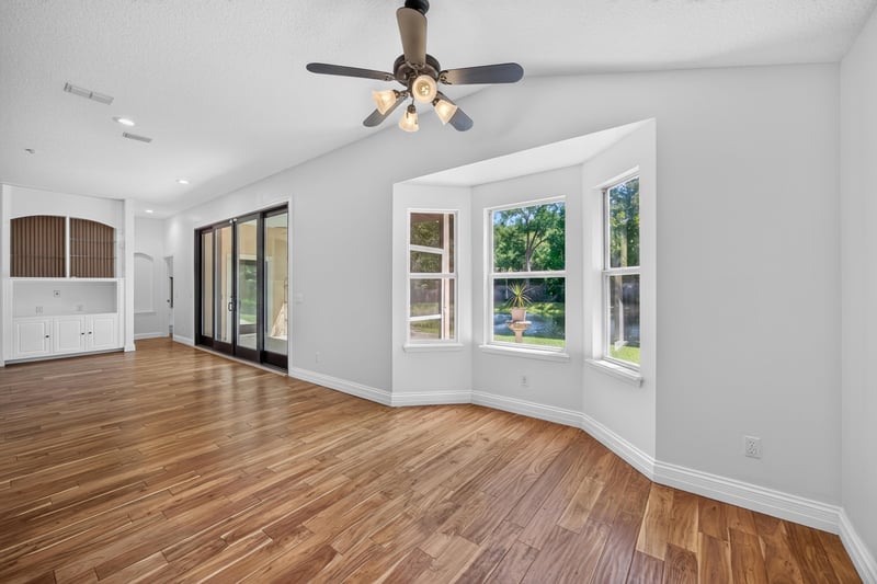 Dining area with wood floors and large windows at 11675 Magnolia Estates Rd, Jacksonville, FL 32223