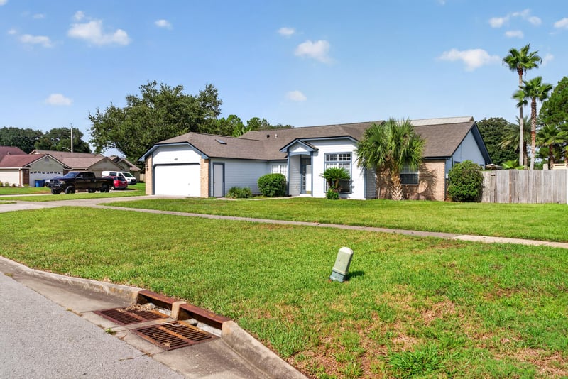 Street view with sidewalk and neighboring homes in Jacksonville, FL