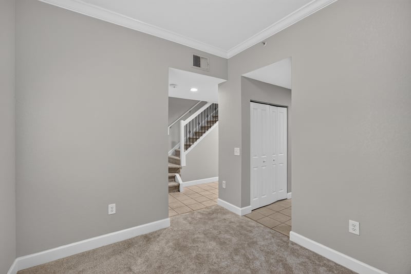 Hallway with staircase and carpet flooring at 9745 Touchton Rd, Jacksonville, FL 32246