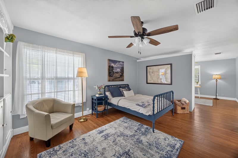 Bedroom with blue metal bed frame and armchair at 5843 Ovella Rd, Jacksonville, FL 32244