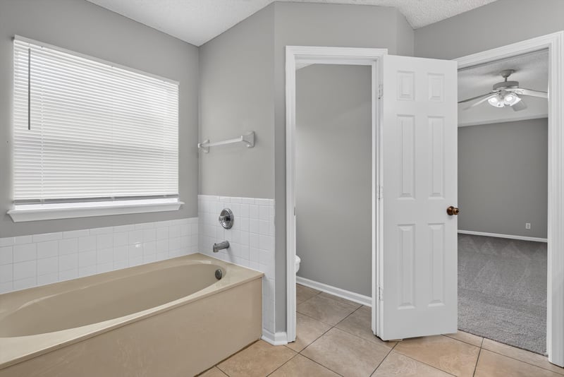 Bedroom closet area with window at 12949 Chets Creek Dr S, Jacksonville, FL 32224