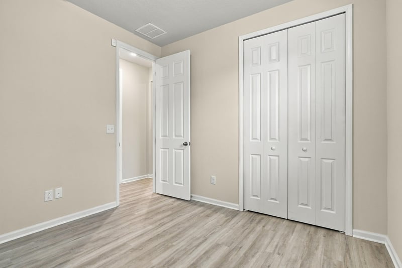 Empty room with closet doors at 7088 Mahogany Run Dr, Jacksonville, FL 32244